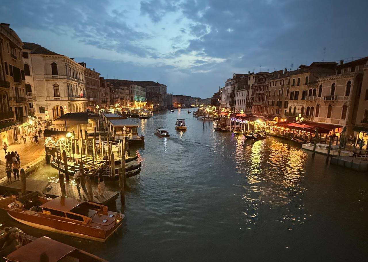 An evening canal scene in Italy, reflecting the atmosphere and romance that inspire VELA.